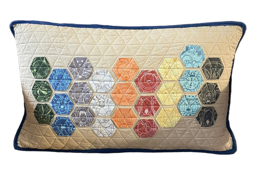 Decorative pillow with hexagonal pattern on a beige background