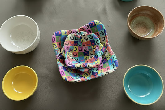 Colorful fabric with a pattern of mustachioed on a gray surface