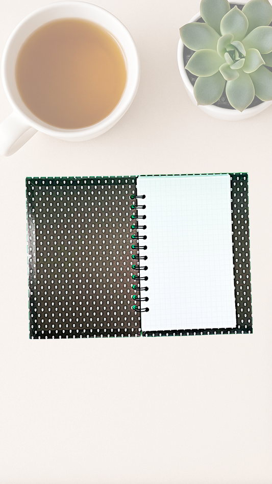 Open Notebook endpapers of tiny white skulls on a black background