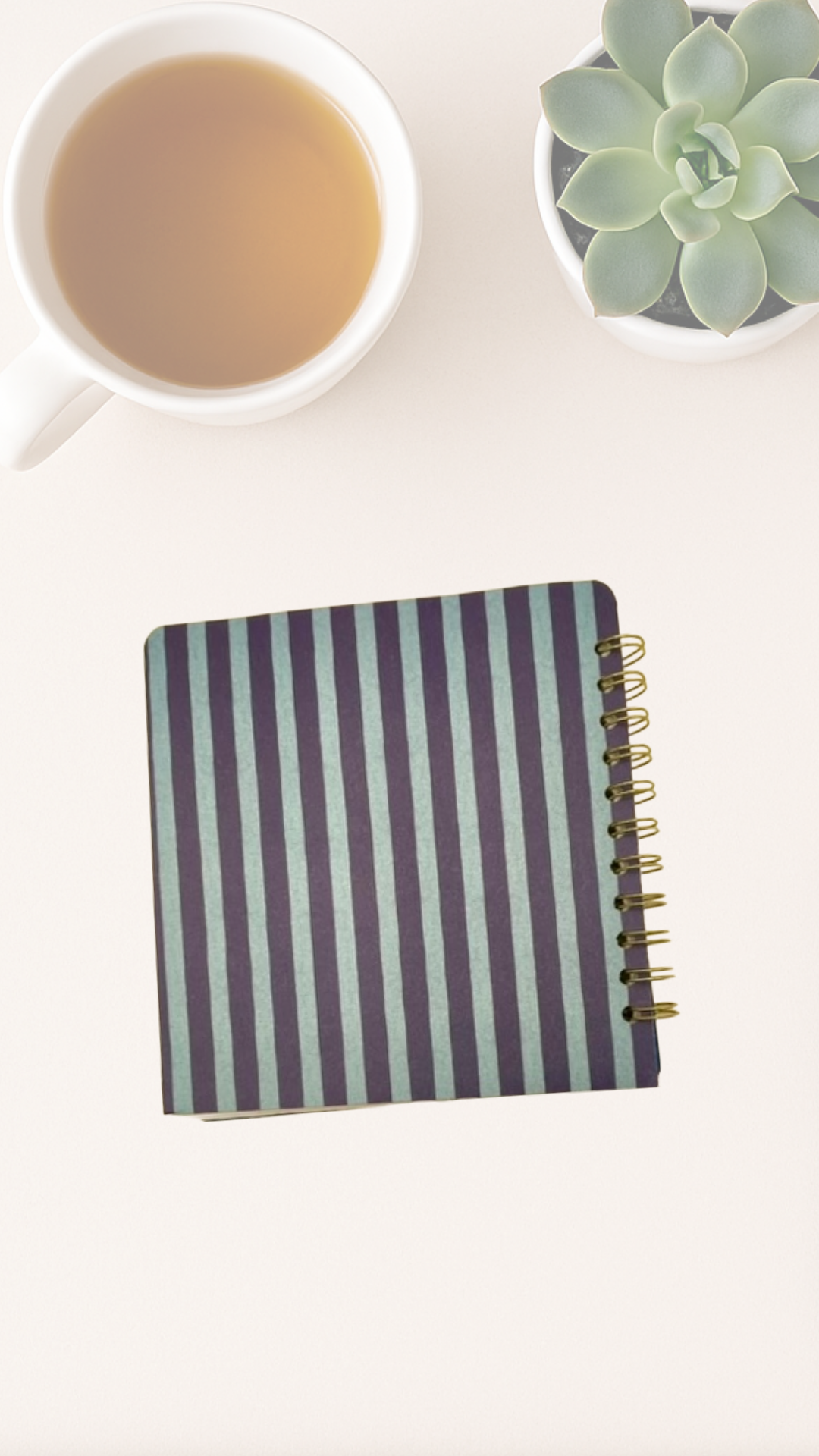 Striped notebook back cover with a cup of tea and succulent plant on a white surface