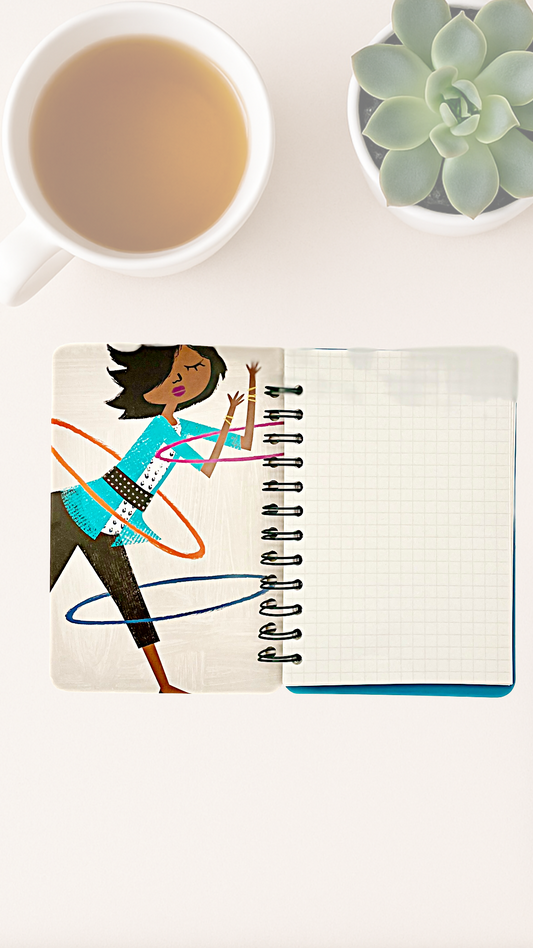 Notebook with Michelle Obama hula hooping on the inside cover with grid paper