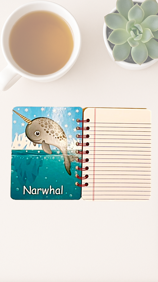 Open notebook with an illustrated narwhal design on inside cover