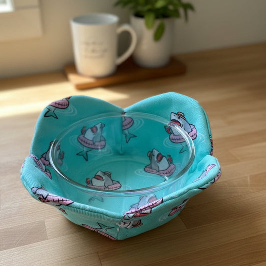 Glass bowl with a shark design fabric cozy