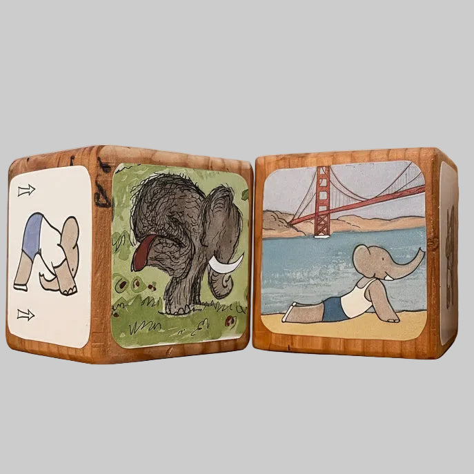 Babar's Elephant Yoga wooden blocks with elephant illustrations on a desk