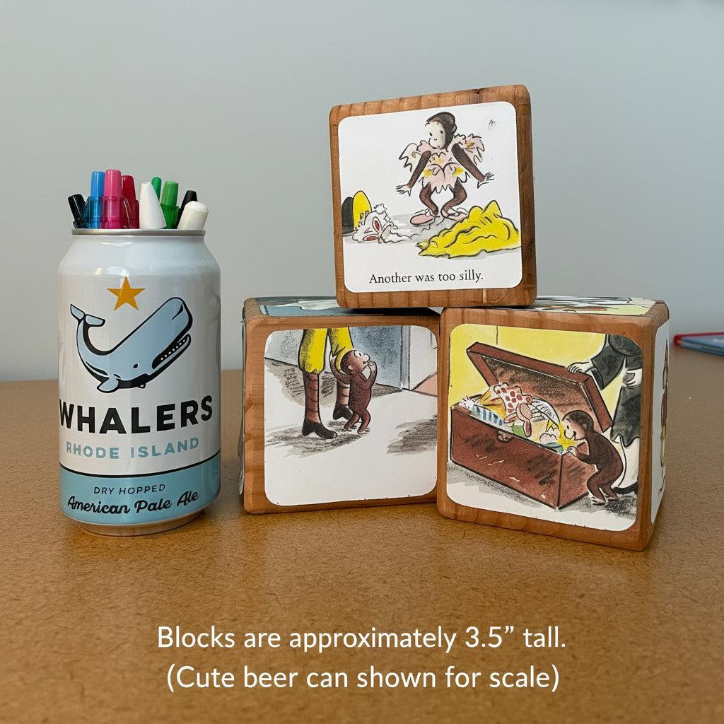 Three wooden blocks with illustrations and a canister with pens on a table.