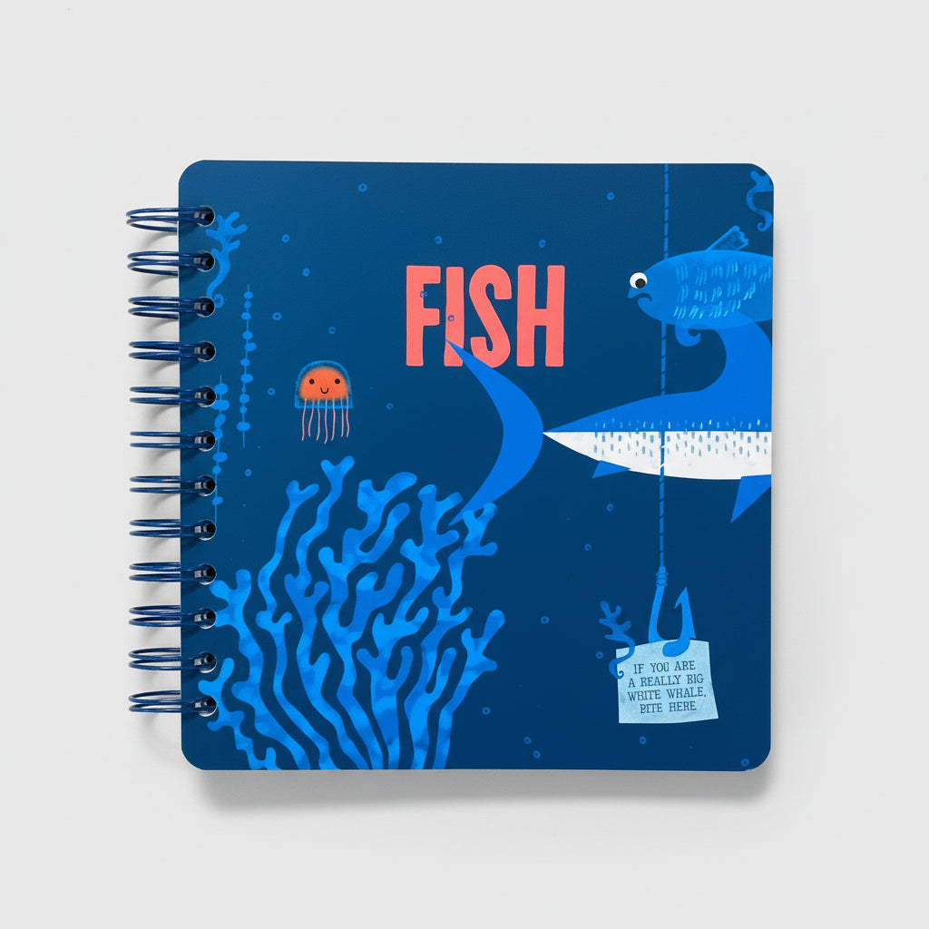 Blue notebook with fish illustrations on a beige surface