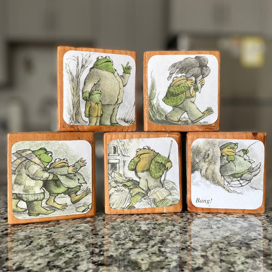 Set of wooden blocks with illustrated scenes on a countertop