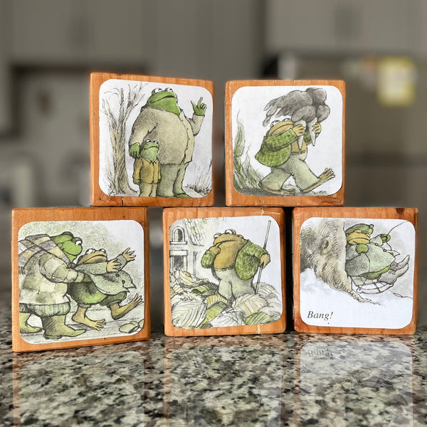 Set of wooden blocks with illustrated scenes on a countertop