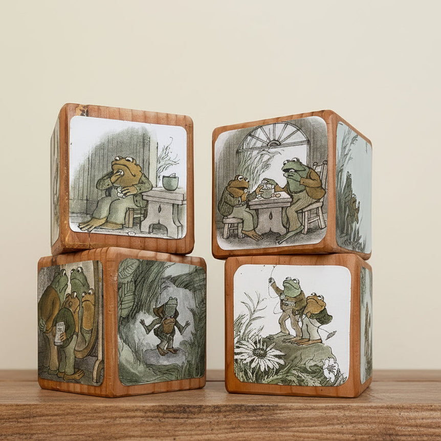 Set of wooden blocks with illustrated Frog and Toad characters on a table