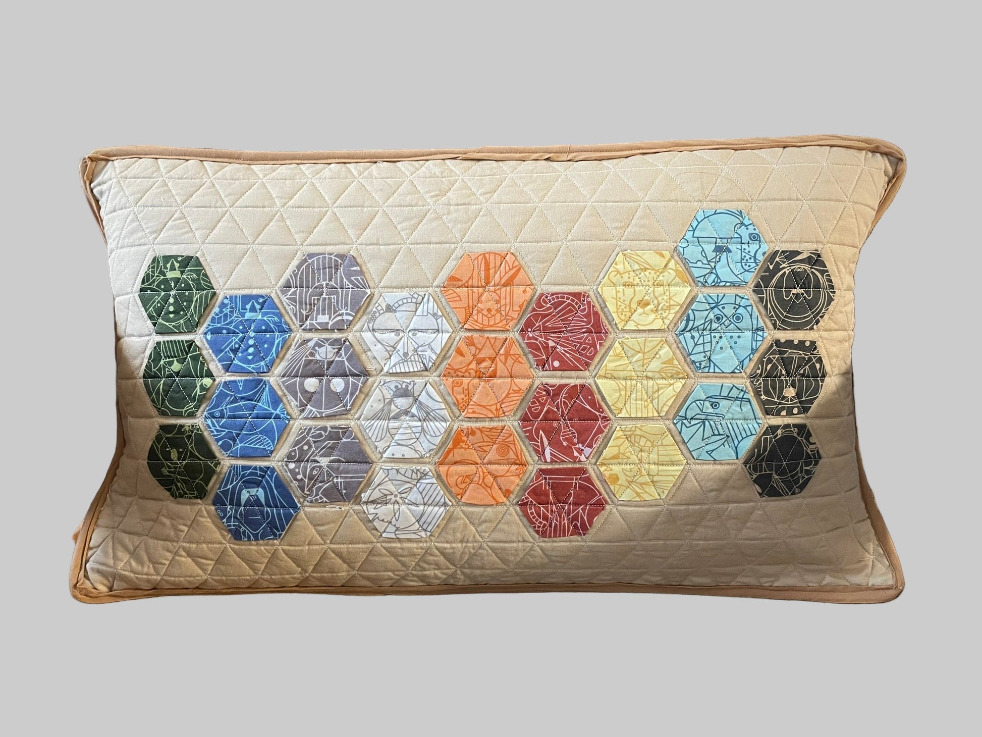 Decorative pillow with hexagonal pattern on a brown chair