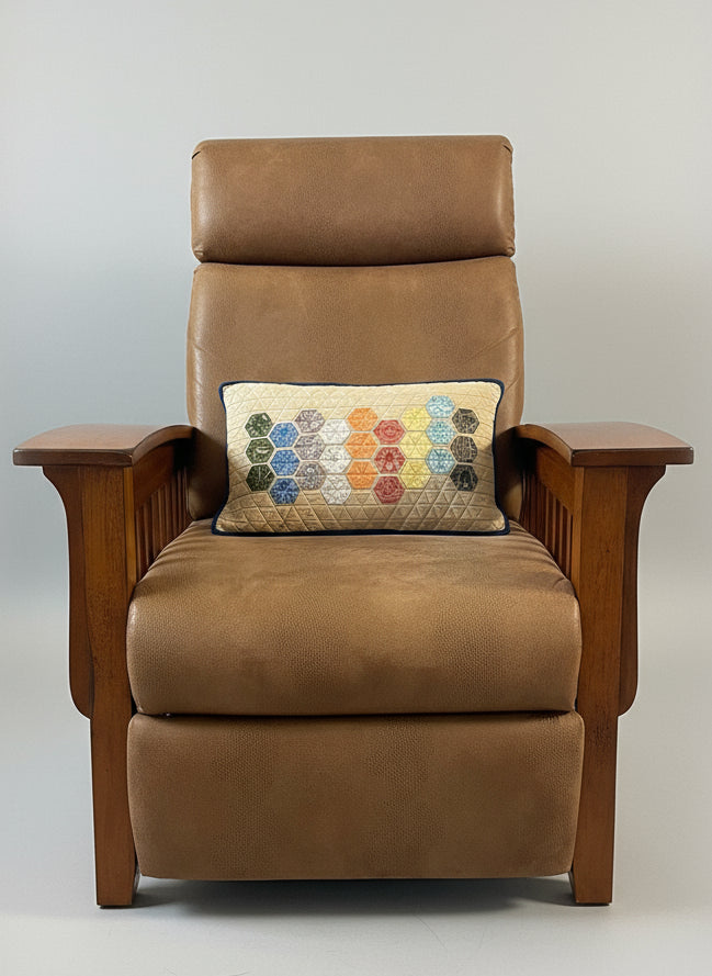Brown recliner chair with a decorative pillow in a living room setting