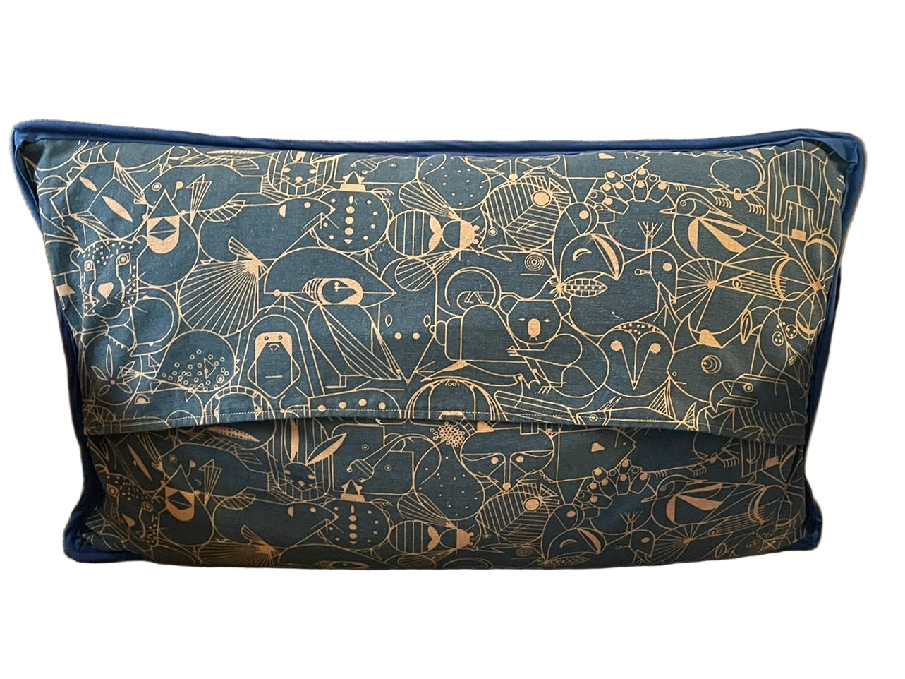 Decorative pillow with blue and gold pattern on a brown chair