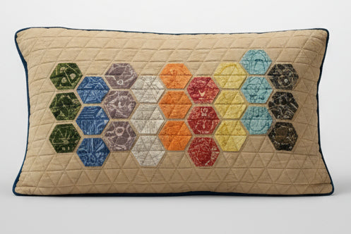 Brown recliner chair with a colorful quilted pillow in a living room setting.