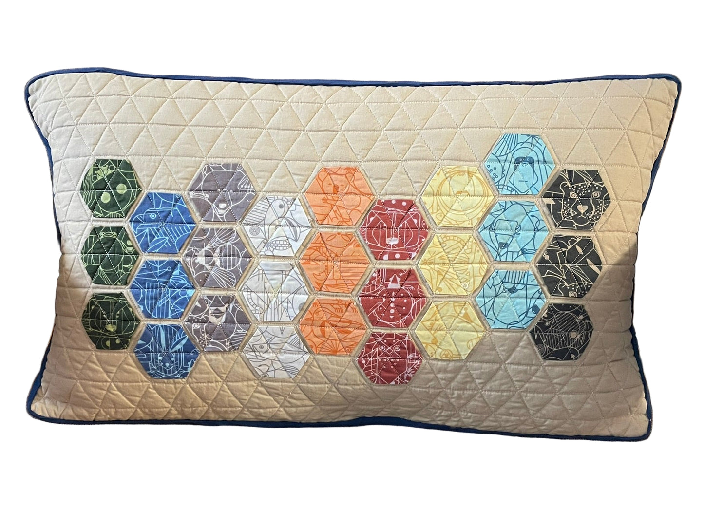 Decorative pillow with hexagonal pattern on a brown chair