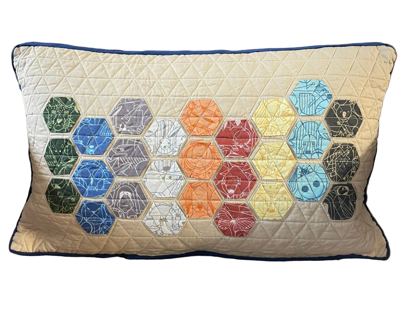 Decorative pillow with hexagonal pattern on a brown chair