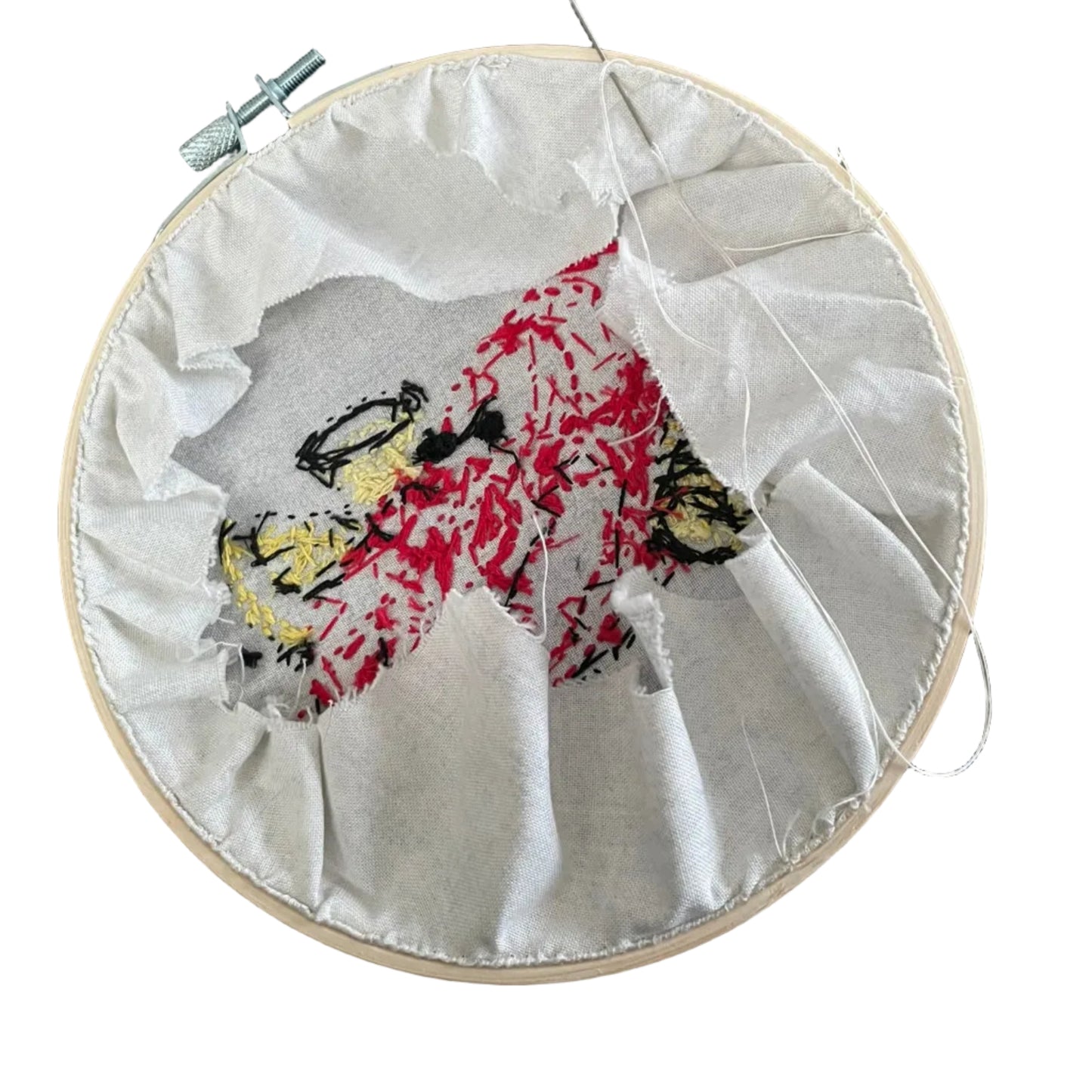 Embroidery hoop with a partially completed piece of art on a patterned floor.