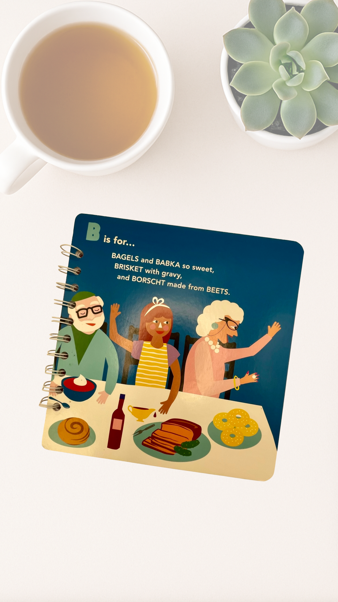 Notebook with illustrations of Jewish people celebrating bagels, babka, borscht and beets