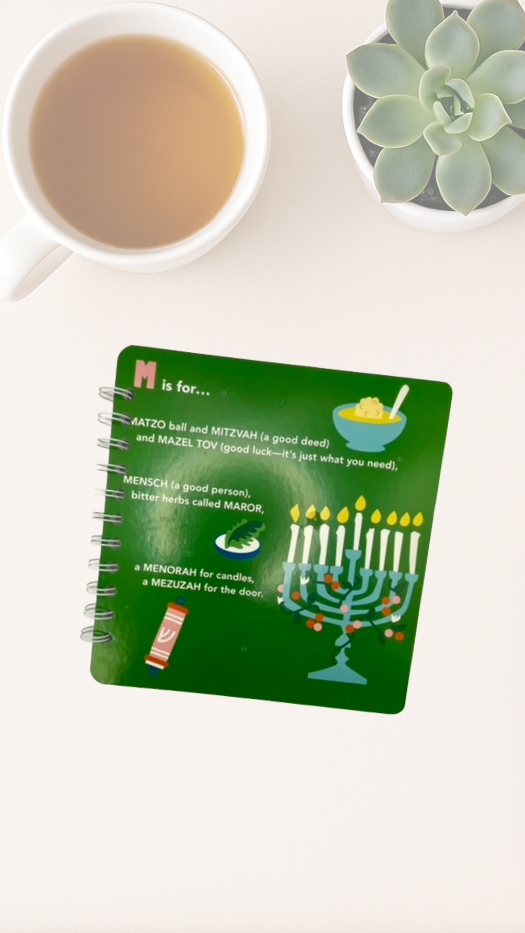 Green cover of spiral notebook with Menorah illustration 