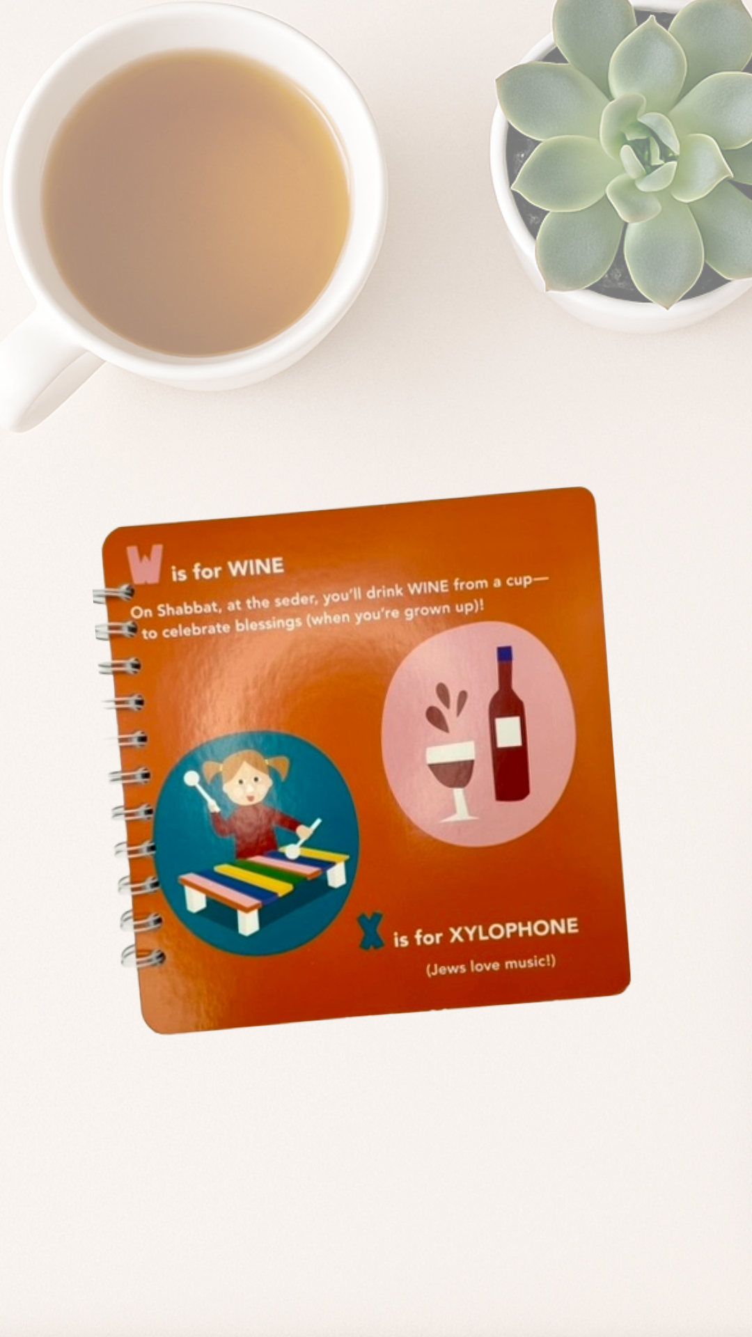 Notebook cover that says W is for Wine and X is for Xylophone