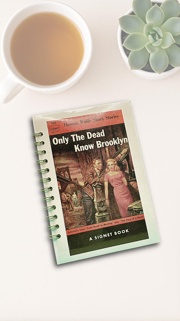 Book titled 'Only The Dead Know Brooklyn' with a cup of tea and succulent plant on a white surface