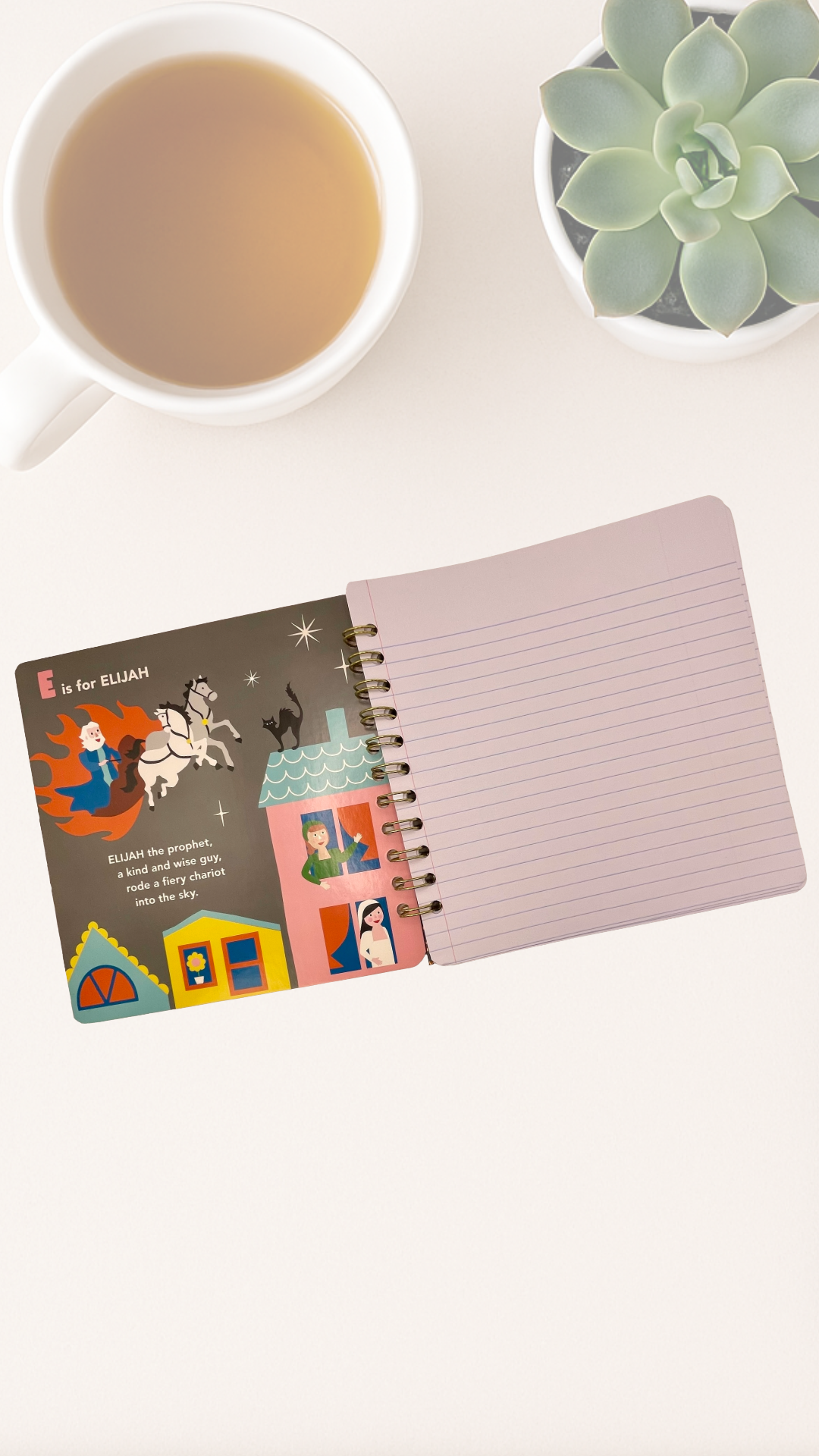 Open notebook with colorful illustrations on a white surface next to a cup of tea and a succulent plant.