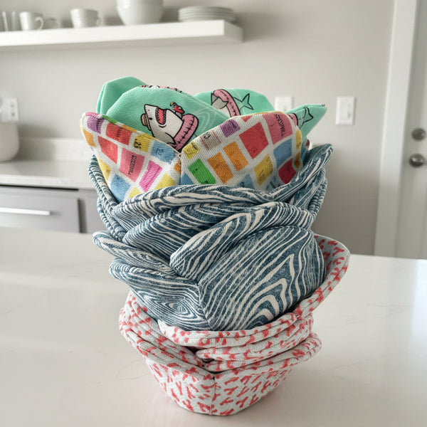 Stack of colorful bowl cozies on a kitchen counter