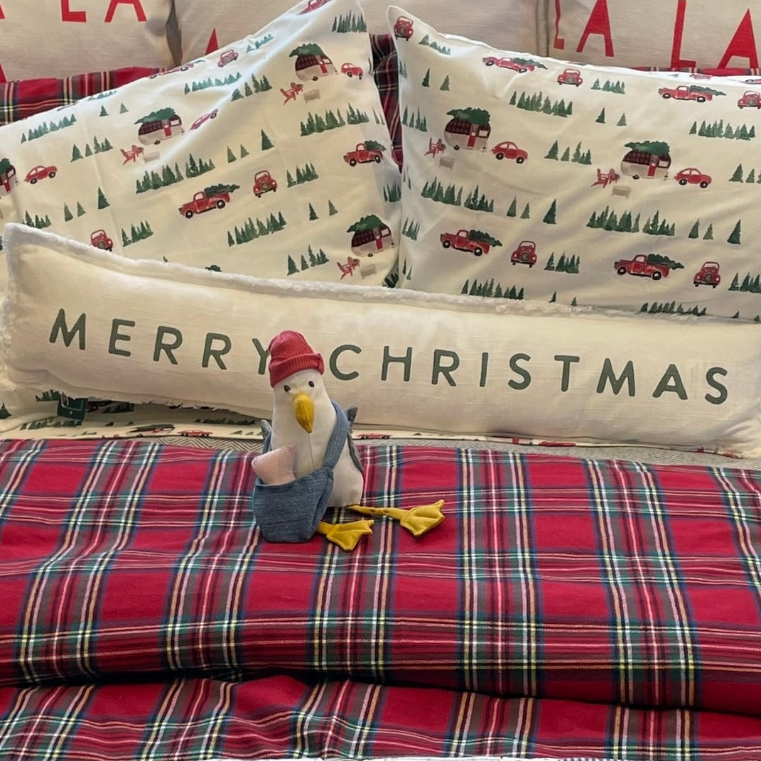 Stuffed Seagull Sitting on Christmas Bed