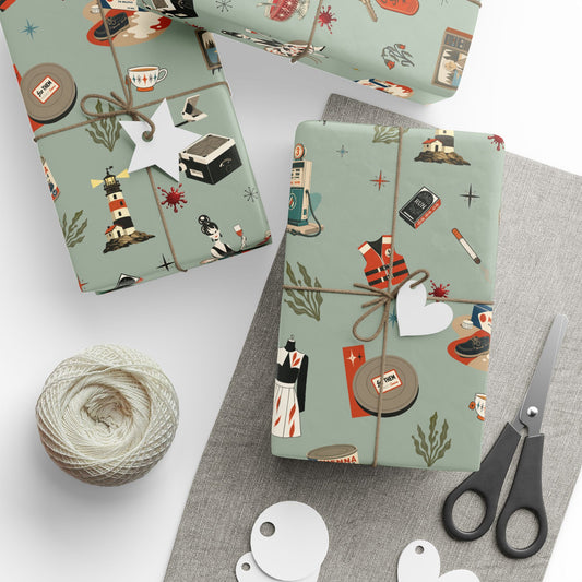 Gift boxes wrapped in patterned paper with a spool of yarn and scissors on a white surface.